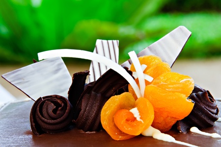Cake decorated with chocolate and dried peachesの写真素材