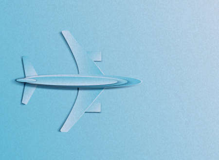 Vector illustration in minimal style of a plane flying in the sky. In the style of cut paper.のイラスト素材