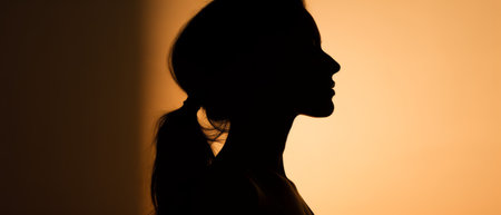 Silhouette of a girl against a sunset background.の素材
