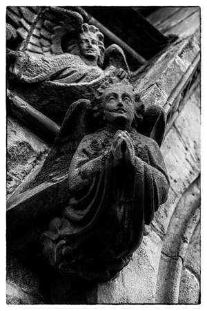 angels made of stone on an old church in irelandの写真素材