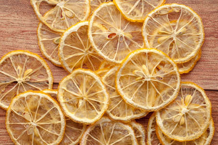Healthy snack. Homemade dehydrated lemon chips on a rustic wooden backgroundの写真素材