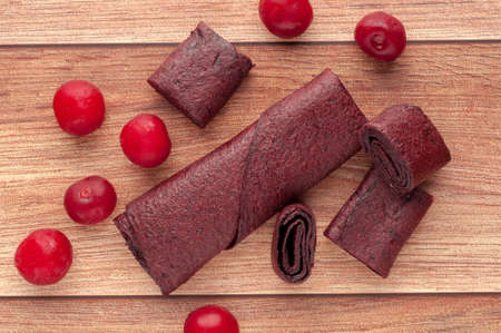 Homemade fruit leather of grape on a wooden background. Pastila. Fruit rolls. Fresh fruitsの写真素材