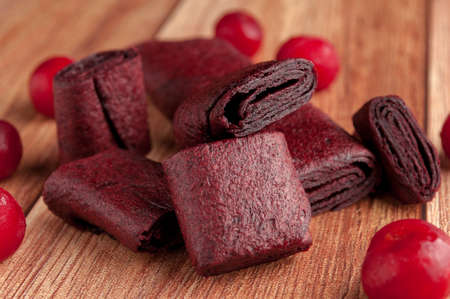 Homemade fruit leather of grape on a wooden background. Pastila. Fruit rolls. Fresh fruitsの写真素材
