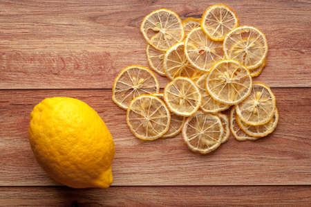 Healthy snack. Homemade dehydrated apple chips and fresh apples on a rustic wooden backgroundの写真素材