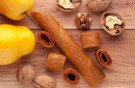 Homemade fruit leather of grape on a wooden background. Pastila. Fruit rolls. Fresh fruitsの写真素材