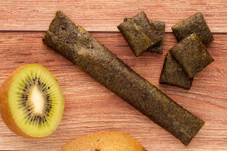Homemade fruit leather of grape on a wooden background. Pastila. Fruit rolls. Fresh fruitsの写真素材