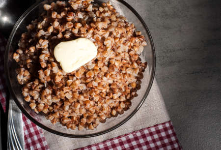 boiled buckwheat porridge in a transparent plate on a gray backgroundの写真素材