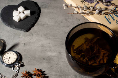 book and cup of tea on grey stone background, top view. Space for textの写真素材