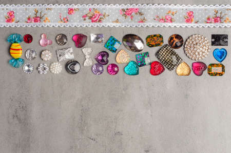 multi-colored sewn stones on a grey background.Copy Spaceの写真素材