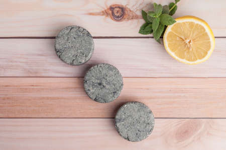 Eco friendly natural solid shampoo and hair conditioner on wooden background. Concept animal fat free, zero waste.の写真素材