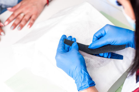 Salon procedure in process. Professional works in gloves for sterilityの写真素材