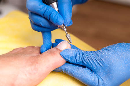 Salon pedicure procedure in process. Professional works in gloves for sterilityの写真素材