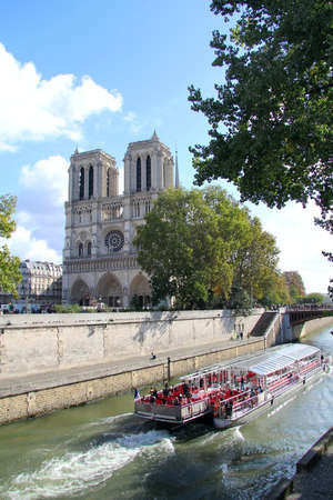 Notre Dame of Paris and Seine river boat . Paris , Franceのeditorial素材