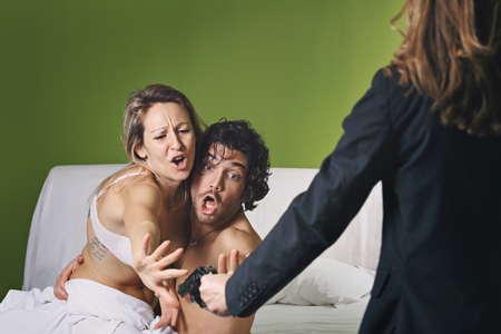 Couple of lovers discovered by wife with gun . Adultery conceptの写真素材