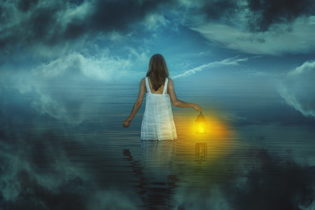 Woman in strange and surreal waters . Weird and fantasyの写真素材
