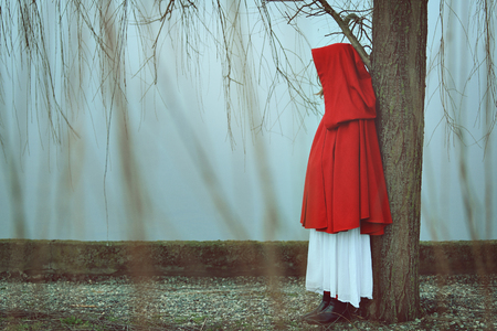 Woman with red cloak in misty and foggy day . Sadness conceptualの写真素材