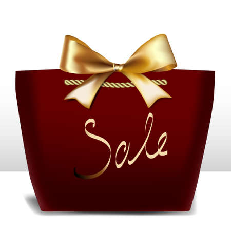 Sale written on a gift bag with a gold ribbonの写真素材