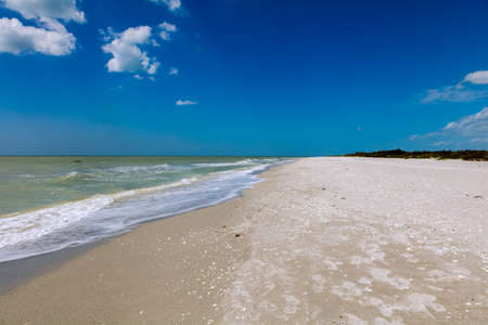 Coast of Sanibel Island, water, sand and blue sky, Florida, USAの写真素材