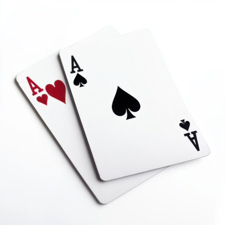 Two playing cards, ace of hearts and ace of spades, neatly placed on a white background, symbolizing luck and gambling conceptsの素材