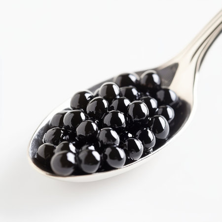 Black caviar on a spoon isolated on white background close upの素材
