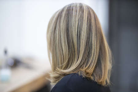 Barber designing good hairstyle of beautiful lady model in the saloonの写真素材
