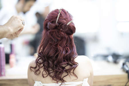 Barber designing good hairstyle of beautiful lady model in the saloonの写真素材