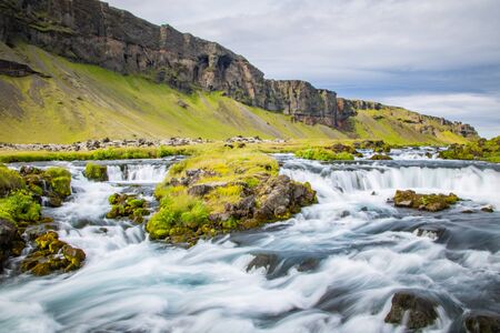 Powerful and magestic waterfall with volcanic rock in an Icelandic landscape2の写真素材