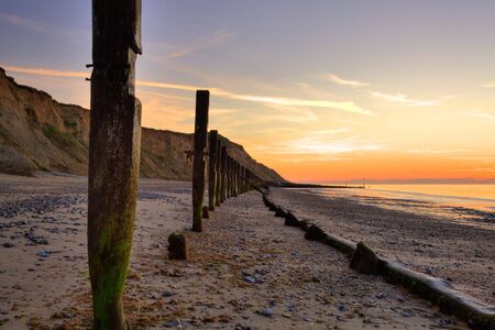 Breakwater on the beach in Norfolk in Great Britainの写真素材