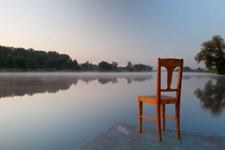 Old chair on the riverの写真素材
