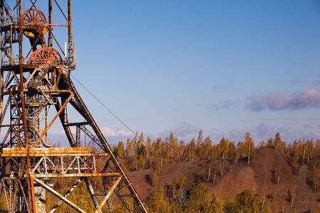 Old industry-Coal Mine and autumn forestの写真素材