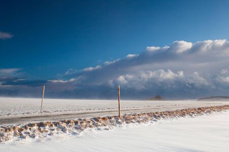 Snowstorm and empty roadの写真素材