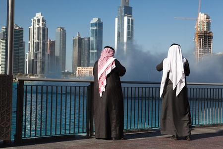 Two Dubai sheiks in front of fountain before Burj Khalifa, Dubai United Arab Emiratesのeditorial素材