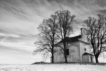 The ruins small church on the hill in winterの写真素材