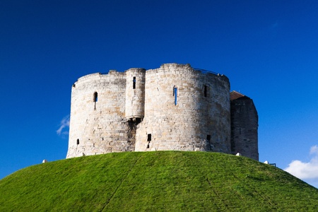 Medieval landmark architecture of cliffords tower in the centre of the historic city of york england under a clear blue skyのeditorial素材