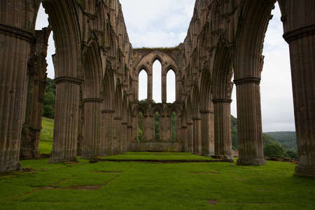 Scenic view of ruins of Rievaulx Abbey under cloudscape, North Yorkshire Moors, National Park, England のeditorial素材