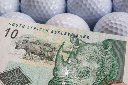 The white golf balls and money from South Africaの写真素材