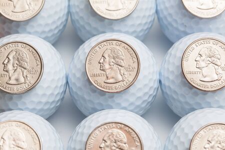 White golf balls and US dollarsの写真素材
