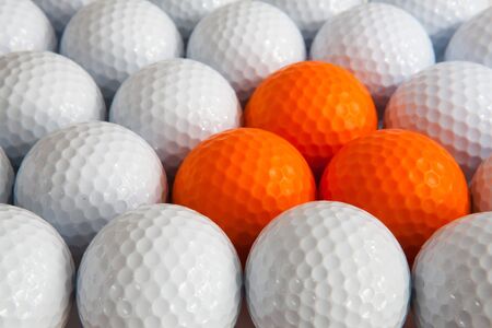 White and orange golf ballsの写真素材