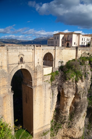 View of buildings in new town from other side of the 18th century bridge over the 300 ft Tajo Gorge in Ronda Spainのeditorial素材