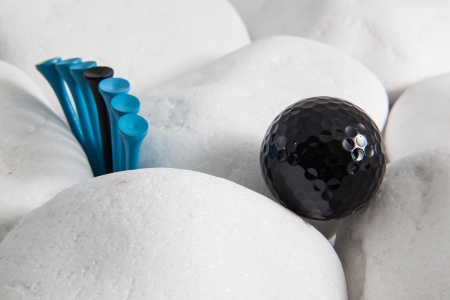 Black golf ball and different wooden teesの写真素材