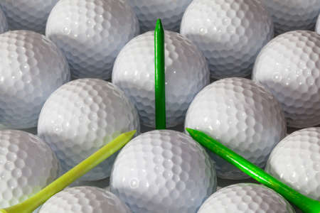 White golf balls and  different wooden tees