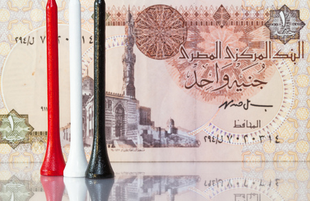Money and golf equipments in Egyptian national colours