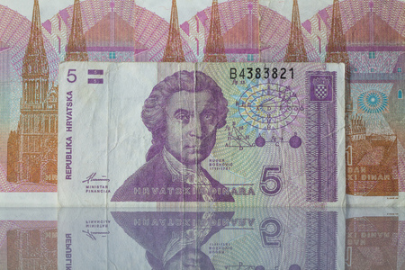 Dinars money from Croatia in a mirror