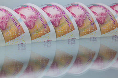 British Fifty pounds on a glass tableの写真素材