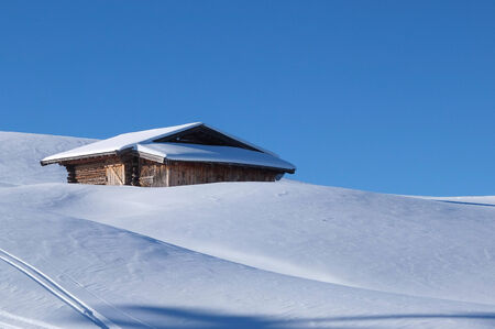 Wooden challet in the Dolomites mountain in winterの写真素材
