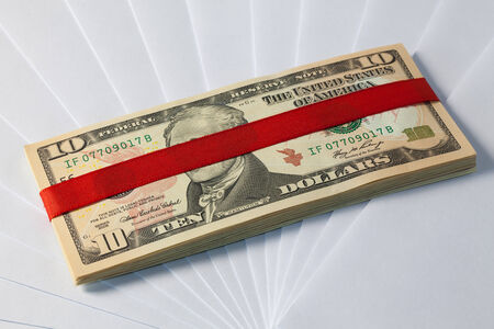 Pack of dollar banknotes on a white envelopes