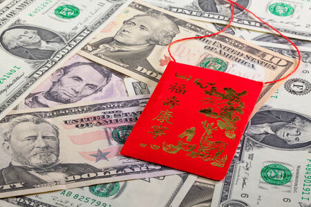 Typical China red envelope and US dollar banknotes