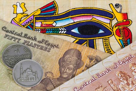 Typical Egyptian hieroglyphics on papyrus and different banknotesの写真素材