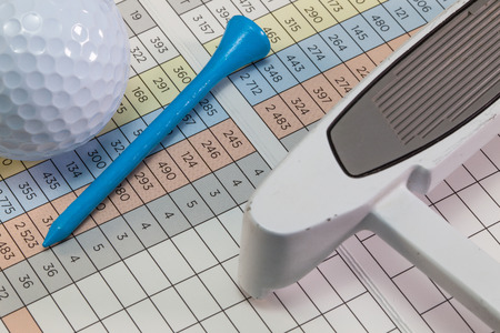 Golf putter and other equipments  lying  on a golf score cardの写真素材