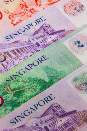 Different banknotes from Singapore on the tableの写真素材